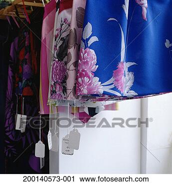 Stock Photography - clothes hanging 
on racks, price 
tags dangling. 
fotosearch - search 
stock photos, 
pictures, images, 
and photo clipart