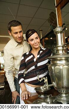 Stock Photography - couple looking 
at samovar in 
antique shop. 
fotosearch - search 
stock photos, 
pictures, images, 
and photo clipart