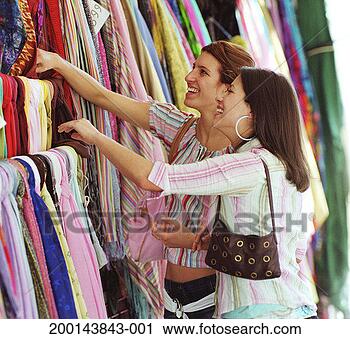 Stock Photography - two young women 
looking at fabrics 
in shop, smiling. 
fotosearch - search 
stock photos, 
pictures, images, 
and photo clipart