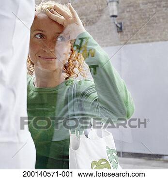 Stock Photography - woman looking 
in shop window, 
view through window. 
fotosearch - search 
stock photos, 
pictures, images, 
and photo clipart