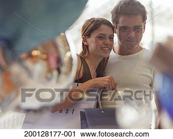 Stock Photography - young couple looking 
in shop window, 
view through window. 
fotosearch - search 
stock photos, 
pictures, images, 
and photo clipart