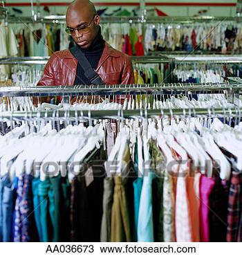 Stock Photo - young man shopping 
for clothing at 
thrift store. 
fotosearch - search 
stock photos, 
pictures, images, 
and photo clipart