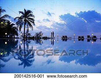 Stock Photography - couple at side 
of outdoor pool, 
woman with arms 
around man's neck. 
fotosearch - search 
stock photos, 
pictures, images, 
and photo clipart