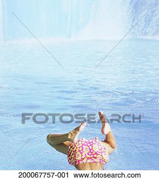 Stock Photography - girl (6-8) diving 
into water, low 
section, rear 
view. fotosearch 
- search stock 
photos, pictures, 
images, and photo 
clipart