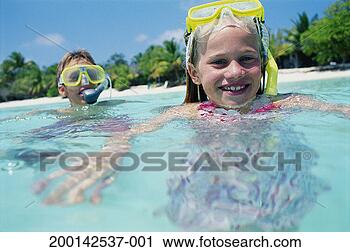 Stock Photography - girl and boy (6-8) 
snorkelling in 
sea, portrait. 
fotosearch - search 
stock photos, 
pictures, images, 
and photo clipart