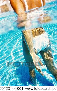Stock Photography - woman wearing 
white bikini walking 
in pool, surface 
view. fotosearch 
- search stock 
photos, pictures, 
images, and photo 
clipart