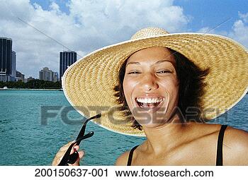 Stock Photography - young woman in 
sun hat, laughing, 
portrait. fotosearch 
- search stock 
photos, pictures, 
images, and photo 
clipart