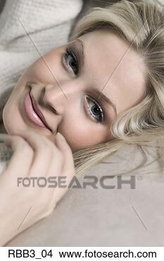 Stock Photo - close up portrait 
of a young blonde 
caucasian woman 
laying on a couch. 
fotosearch - search 
stock photos, 
pictures, images, 
and photo clipart