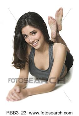 Stock Photo - full body portrait 
of a young woman 
in a workout outfit 
as she lays. fotosearch 
- search stock 
photos, pictures, 
images, and photo 
clipart