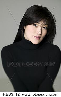 Stock Photo - head and shoulders 
portrait of a 
young asian woman 
in a black sweater. 
fotosearch - search 
stock photos, 
pictures, images, 
and photo clipart