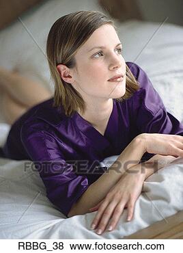 Stock Photo - beautiful woman 
lying in bed with 
purple satin pajamas 
deep in thought. 
fotosearch - search 
stock photos, 
pictures, images, 
and photo clipart