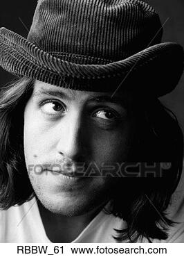 Stock Photography - a caucasian man 
looks up from 
a floppy hat and 
long hair. fotosearch 
- search stock 
photos, pictures, 
images, and photo 
clipart