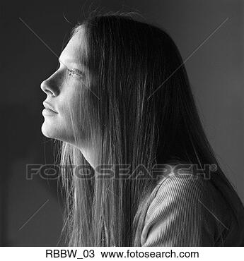 Stock Photo - a caucasian teenage 
girl with long 
hair sits pensively. 
fotosearch - search 
stock photos, 
pictures, images, 
and photo clipart