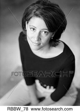 Stock Photo - a caucasian woman 
with dark hair 
sits patiently 
looking up. fotosearch 
- search stock 
photos, pictures, 
images, and photo 
clipart