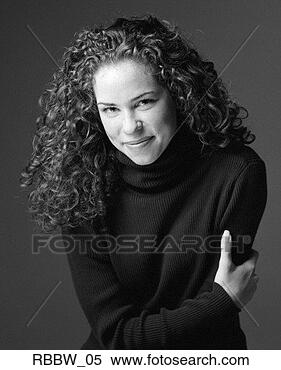 Stock Image - a caucasian woman 
with long curly 
hair holds her 
arm and smiles. 
fotosearch - search 
stock photos, 
pictures, images, 
and photo clipart