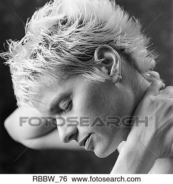 Stock Photo - a caucasian woman 
with short blonde 
hair holds her 
neck. fotosearch 
- search stock 
photos, pictures, 
images, and photo 
clipart