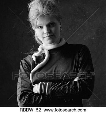 Stock Photo - a caucasian woman 
stands with her 
arms folded and 
a white snake. 
fotosearch - search 
stock photos, 
pictures, images, 
and photo clipart