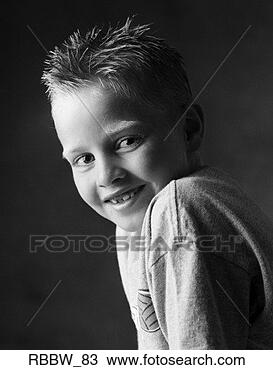 Stock Photo - a little caucasian 
boy smiles over 
his shoulder. 
fotosearch - search 
stock photos, 
pictures, images, 
and photo clipart