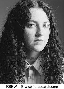 Stock Photograph - a long curly haired 
caucasian teen 
with attitude 
glares at the 
camera. fotosearch 
- search stock 
photos, pictures, 
images, and photo 
clipart