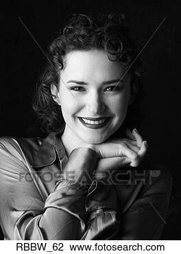 Stock Photo - a perky caucasian 
woman smiles with 
her hands under 
her chin. fotosearch 
- search stock 
photos, pictures, 
images, and photo 
clipart