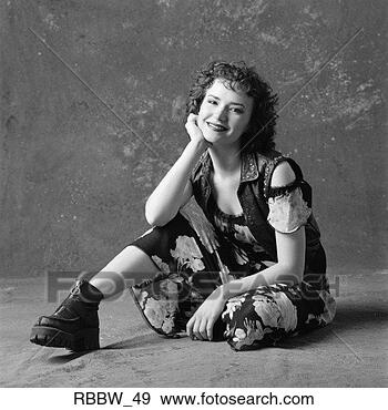 Stock Photograph - a spunky caucasian 
girl sits on the 
floor and smiles. 
fotosearch - search 
stock photos, 
pictures, images, 
and photo clipart
