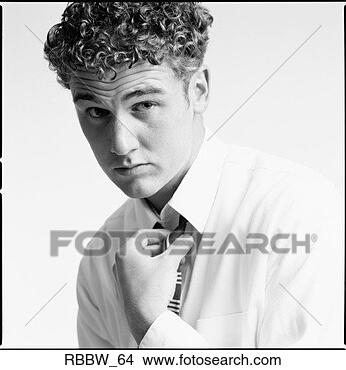 Stock Photo - a well dressed 
caucasian male 
straightens his 
tie with attitude. 
fotosearch - search 
stock photos, 
pictures, images, 
and photo clipart