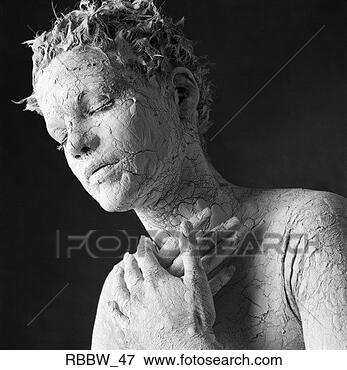 Picture - a white clay-covered 
woman rests with 
her hands raised 
to her chest. 
fotosearch - search 
stock photos, 
pictures, images, 
and photo clipart