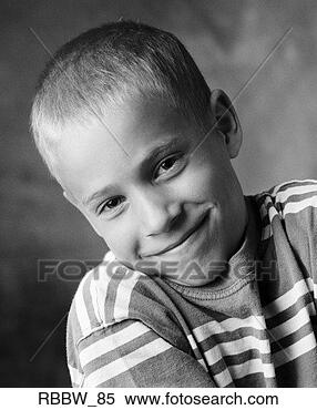 Stock Image - a young caucasian 
boy shrugs a sheepish 
grin. fotosearch 
- search stock 
photos, pictures, 
images, and photo 
clipart