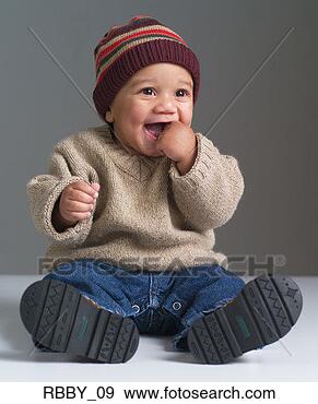 Stock Photograph - an african american 
baby puts his 
hand in his mouth 
and laughs. fotosearch 
- search stock 
photos, pictures, 
images, and photo 
clipart