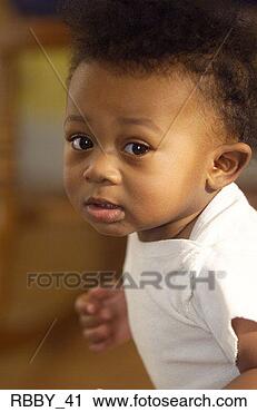 Stock Photography - an african american 
baby looks up 
as if he is gettin 
gin trouble. fotosearch 
- search stock 
photos, pictures, 
images, and photo 
clipart