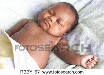 Picture - an african american 
baby lies on its 
back and sleeps 
peacefully. fotosearch 
- search stock 
photos, pictures, 
images, and photo 
clipart