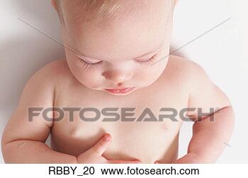 Stock Photography - a caucasian naked 
baby lies on its 
back and sleeps. 
fotosearch - search 
stock photos, 
pictures, images, 
and photo clipart