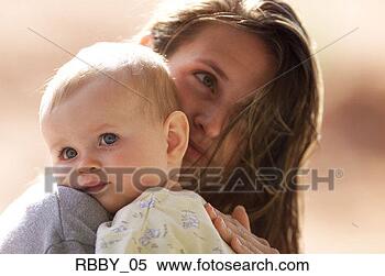 Stock Image - a cute caucasian 
baby is held close 
by her mother. 
fotosearch - search 
stock photos, 
pictures, images, 
and photo clipart