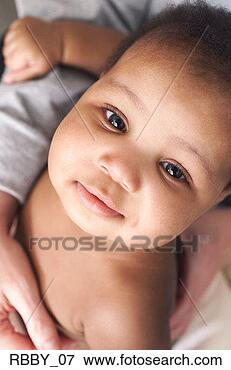 Picture - a naked african 
american baby 
looks from his 
mothers arms. 
fotosearch - search 
stock photos, 
pictures, images, 
and photo clipart