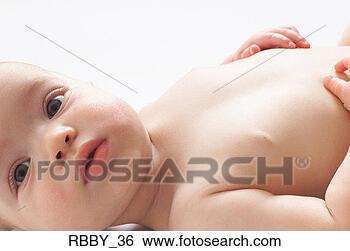 Stock Photo - a naked caucasian 
baby lays on its 
back and touches 
its stomach. fotosearch 
- search stock 
photos, pictures, 
images, and photo 
clipart