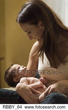 Stock Photo - a young caucasian 
mother holds her 
newborn baby and 
looks lovingly 
at. fotosearch 
- search stock 
photos, pictures, 
images, and photo 
clipart