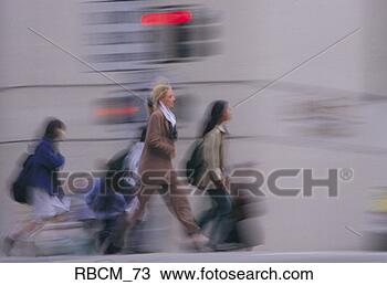 Stock Photo - a blurred businesswoman 
dressed in a brown 
suit crosses an. 
fotosearch - search 
stock photos, 
pictures, images, 
and photo clipart