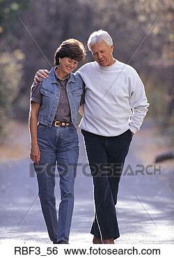 Stock Photo - an older man wearing 
black pants and 
a white shirt 
and an older woman. 
fotosearch - search 
stock photos, 
pictures, images, 
and photo clipart