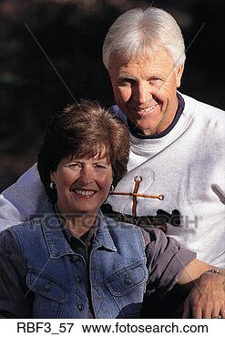Picture - an older man wearing 
a white shirt 
sits behind an 
older woman wearing. 
fotosearch - search 
stock photos, 
pictures, images, 
and photo clipart