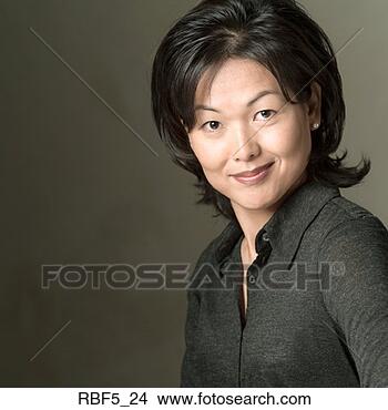 Stock Photo - portrait of an 
attractive asian 
woman in a black 
shirt as she smiles. 
fotosearch - search 
stock photos, 
pictures, images, 
and photo clipart