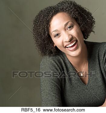Stock Photo - portrait of a 
young african 
american woman 
in a grey sweater 
as she. fotosearch 
- search stock 
photos, pictures, 
images, and photo 
clipart