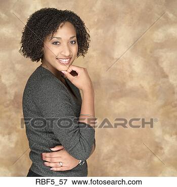 Picture - portrait of a 
young african 
american woman 
grey sweater holds 
up her. fotosearch 
- search stock 
photos, pictures, 
images, and photo 
clipart