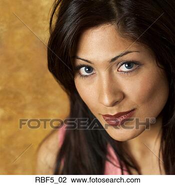 Stock Photo - portrait of a 
young attractive 
hispanic woman 
in a pink blouse 
as she. fotosearch 
- search stock 
photos, pictures, 
images, and photo 
clipart
