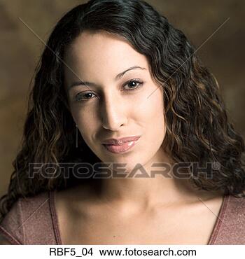 Stock Photo - portrait of a 
young attractive 
ethnic looking 
woman as she smiles. 
fotosearch - search 
stock photos, 
pictures, images, 
and photo clipart