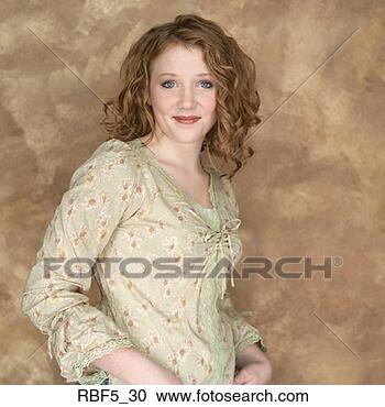 Stock Photography - portrait of a 
young attractive 
redhead in yellow 
blouse as she 
smiles. fotosearch 
- search stock 
photos, pictures, 
images, and photo 
clipart