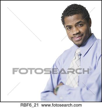 Stock Photography - portrait of a 
young adult male 
in a blue shirt 
and tie as he 
folds. fotosearch 
- search stock 
photos, pictures, 
images, and photo 
clipart