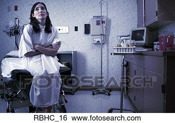 Stock Photo - a caucasian female 
patient in a hospital 
gown sits in an 
exam room. fotosearch 
- search stock 
photos, pictures, 
images, and photo 
clipart