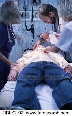 Stock Photo - a caucasian male 
doctor and two 
nurses check the 
vital signs of 
a. fotosearch 
- search stock 
photos, pictures, 
images, and photo 
clipart