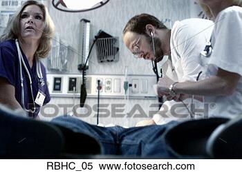 Stock Image - low angle photo 
of a caucasian 
doctor and two 
nurses examine 
a. fotosearch 
- search stock 
photos, pictures, 
images, and photo 
clipart