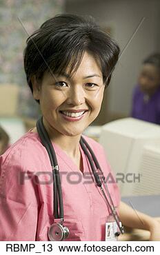 Stock Photo - portrait of an 
adult female in 
pink scrubs as 
she stands by 
the. fotosearch 
- search stock 
photos, pictures, 
images, and photo 
clipart